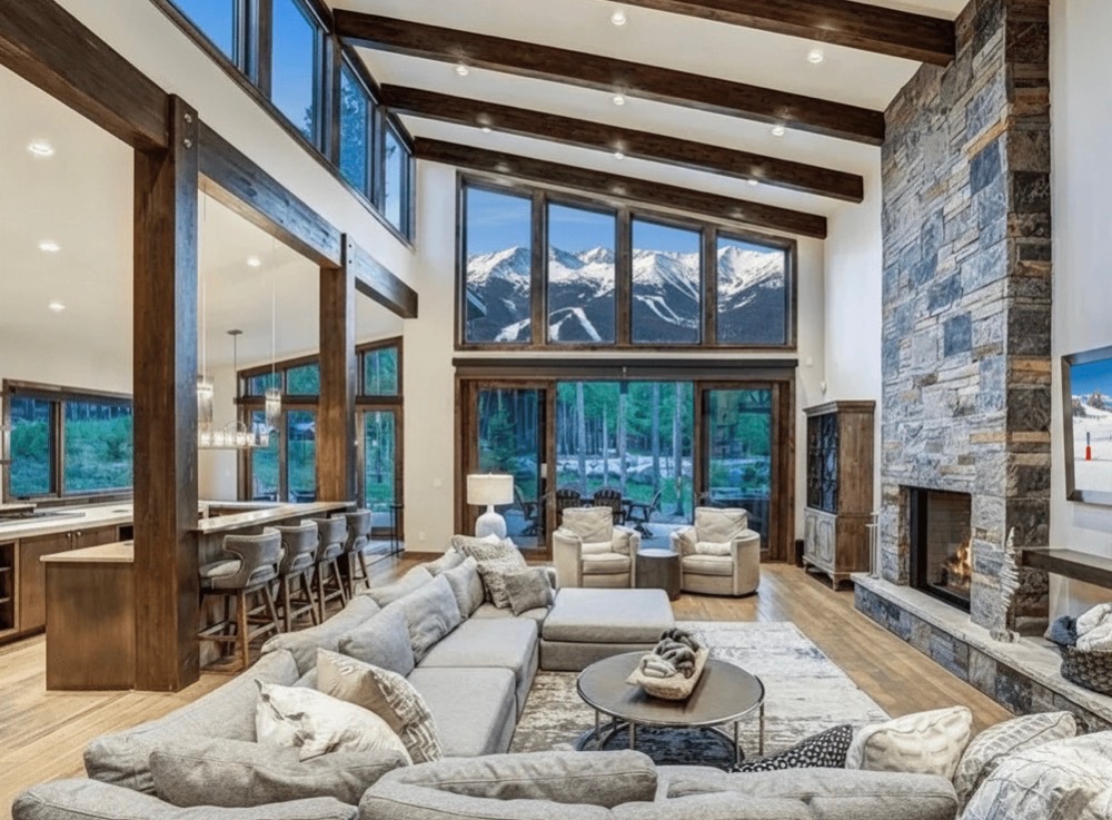 Grand living room with mountain views and stone fireplace